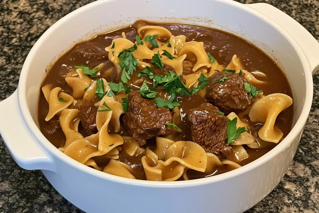 Close-up of crockpot beef tips and noodles in a bowl