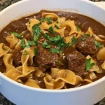 Close-up of crockpot beef tips and noodles in a bowl